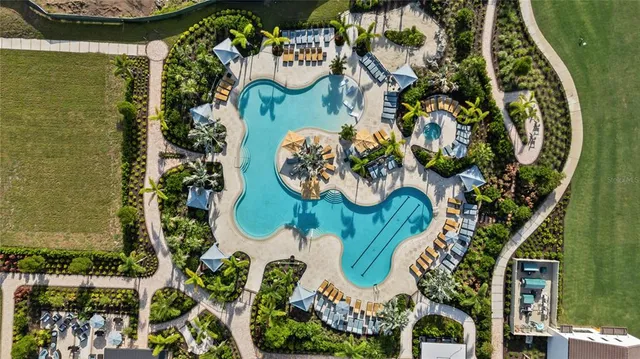 an aerial view of a swimming pool patio and outdoor seating