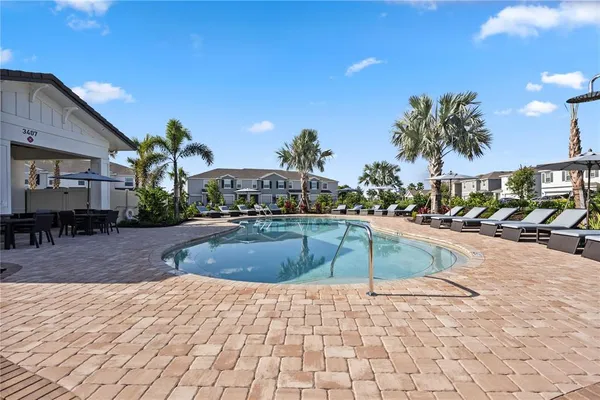 a swimming pool with outdoor seating and yard