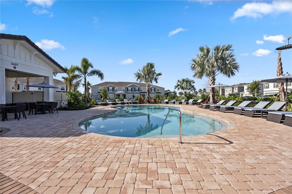 3703 Hatchery Way Lakewood Ranch, FL 34211 - Photo 30 of 35 a swimming pool with outdoor seating and yard