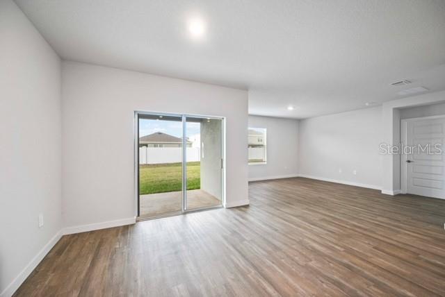 3703 Hatchery Way Lakewood Ranch, FL 34211 - Photo 7 of 35 wooden floor in an empty room with a window