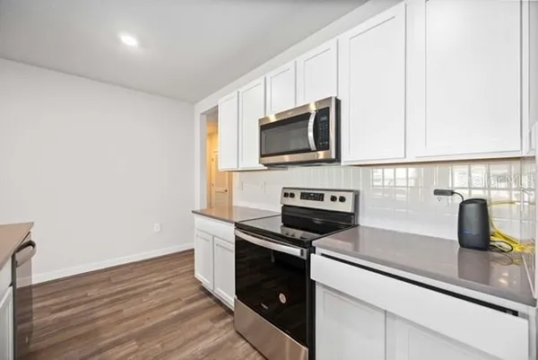 a kitchen with a sink and steel appliances