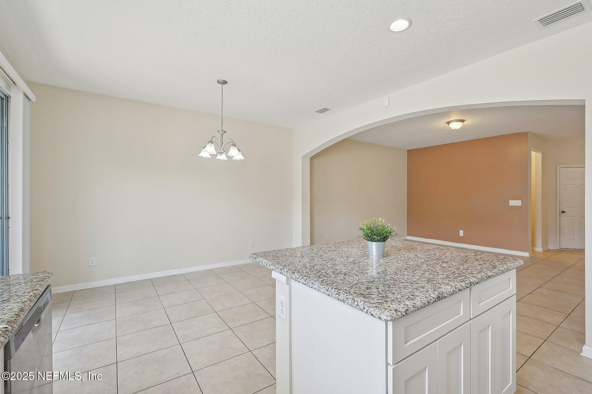 53 Nelson Lane St. Johns, FL 32259 - Photo 15 of 37 a kitchen with kitchen island granite countertop living room and a couch