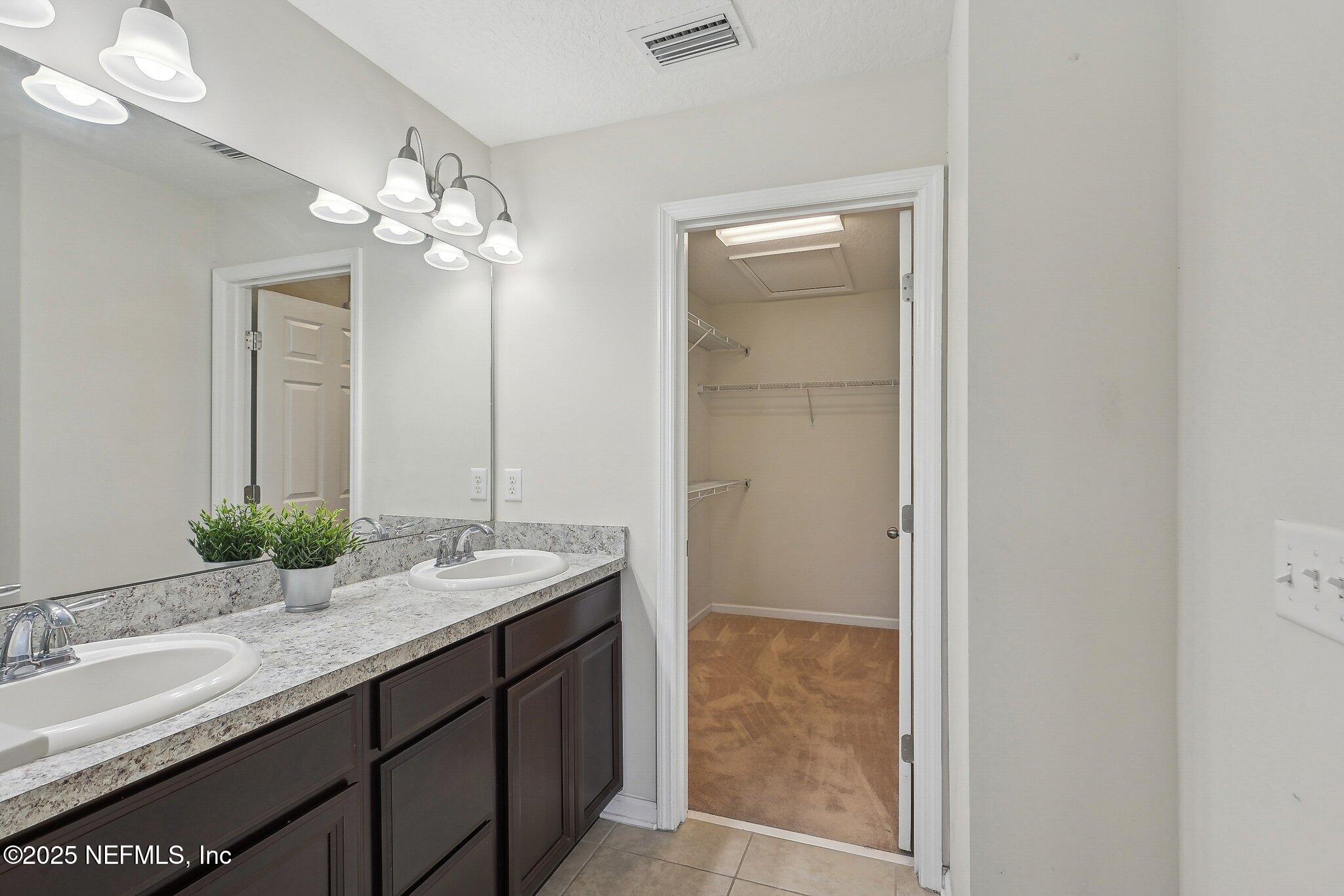 53 Nelson Lane St. Johns, FL 32259 - Photo 22 of 37 a bathroom with a granite countertop sink and a mirror