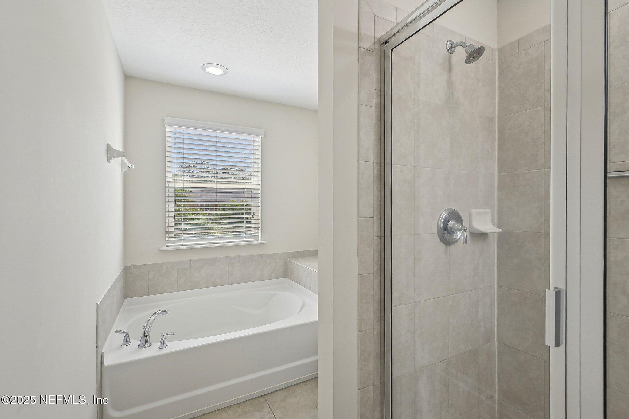 53 Nelson Lane St. Johns, FL 32259 - Photo 24 of 37 a bathroom with a shower and a bath tub