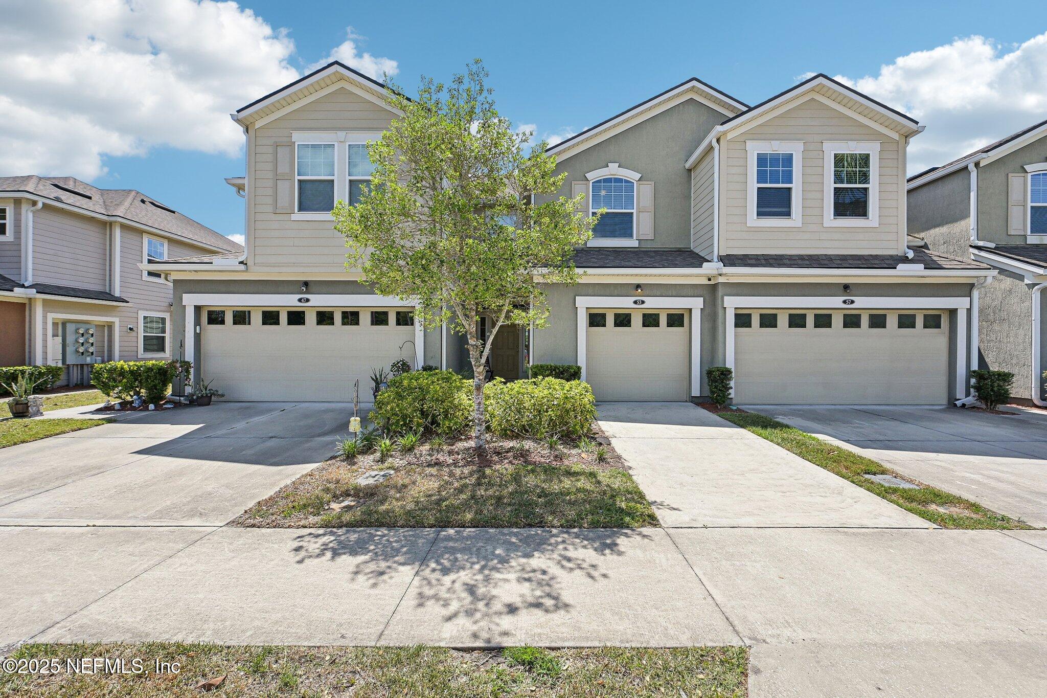 53 Nelson Lane St. Johns, FL 32259 - Photo 6 of 37 a front view of a house with a yard and garage