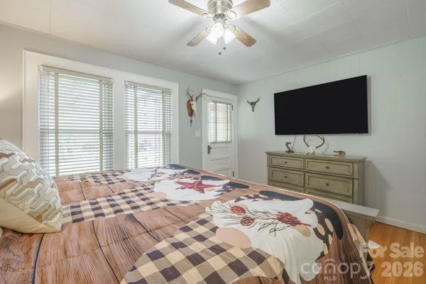 a bedroom with a bed and a flat screen tv