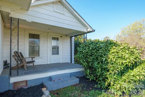 a front view of a house with outdoor seating