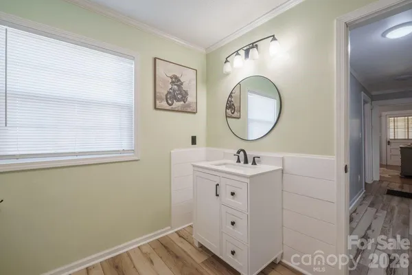 a bathroom with a sink mirror and vanity