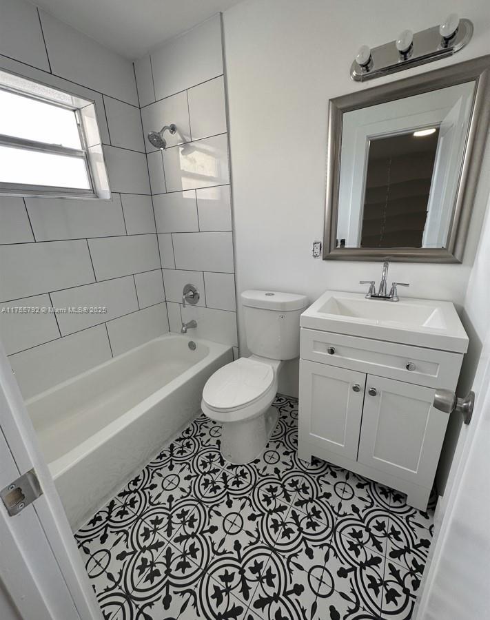 25 West 6th Street, Unit 25 Hialeah, FL 33010 - Photo 5 of 7 a bathroom with a sink toilet a mirror and bathtub