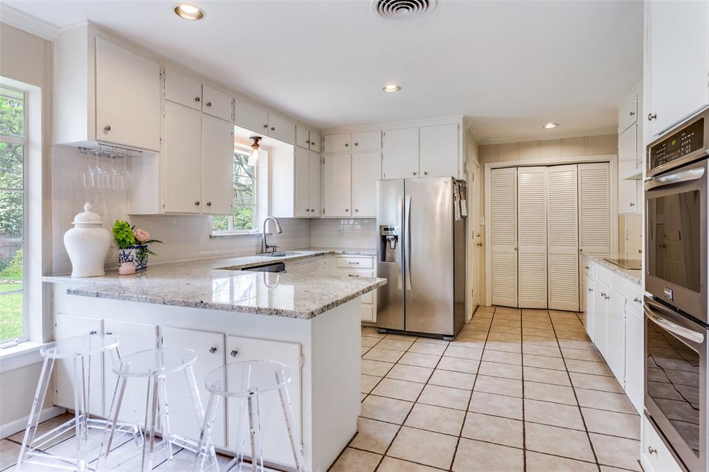 6491 Kirkwood Road Fort Worth, TX 76116 - Photo 14 of 25 a kitchen with stainless steel appliances granite countertop a stove a sink a refrigerator a counter top space and cabinets