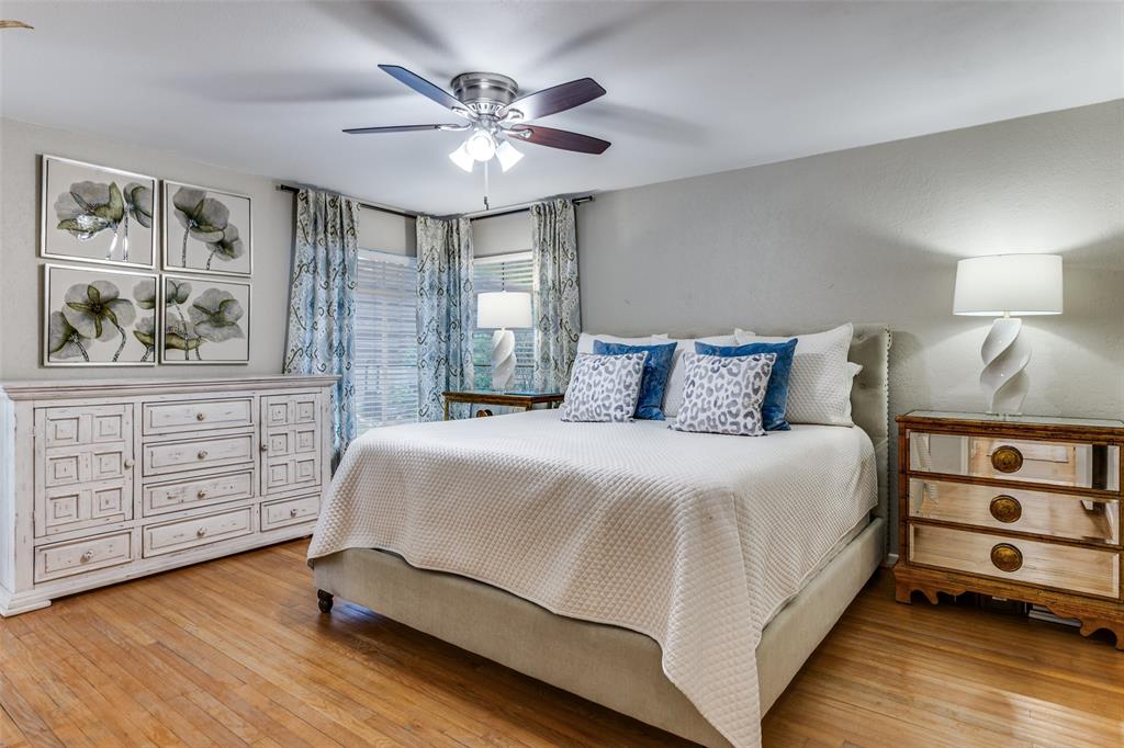 6491 Kirkwood Road Fort Worth, TX 76116 - Photo 17 of 25 a bedroom with a large bed and a chandelier