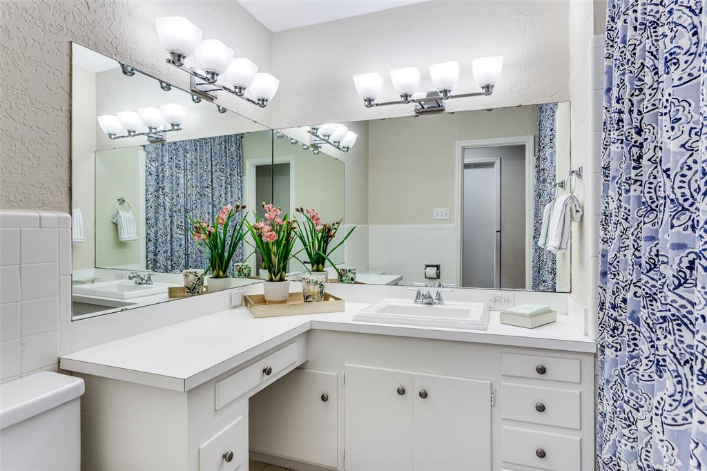 6491 Kirkwood Road Fort Worth, TX 76116 - Photo 21 of 25 a bathroom with a sink double vanity and a mirror