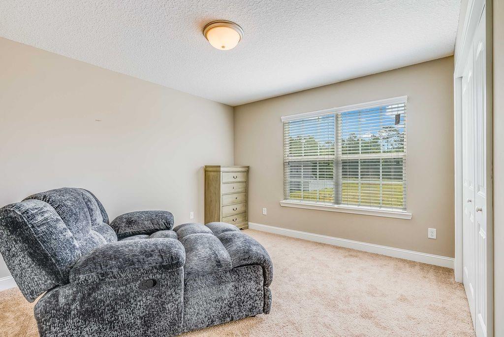 1200 Cypress Fall Circle Hinesville, GA 31313 - Photo 12 of 24 a bed sitting in a spacious bedroom next to a window