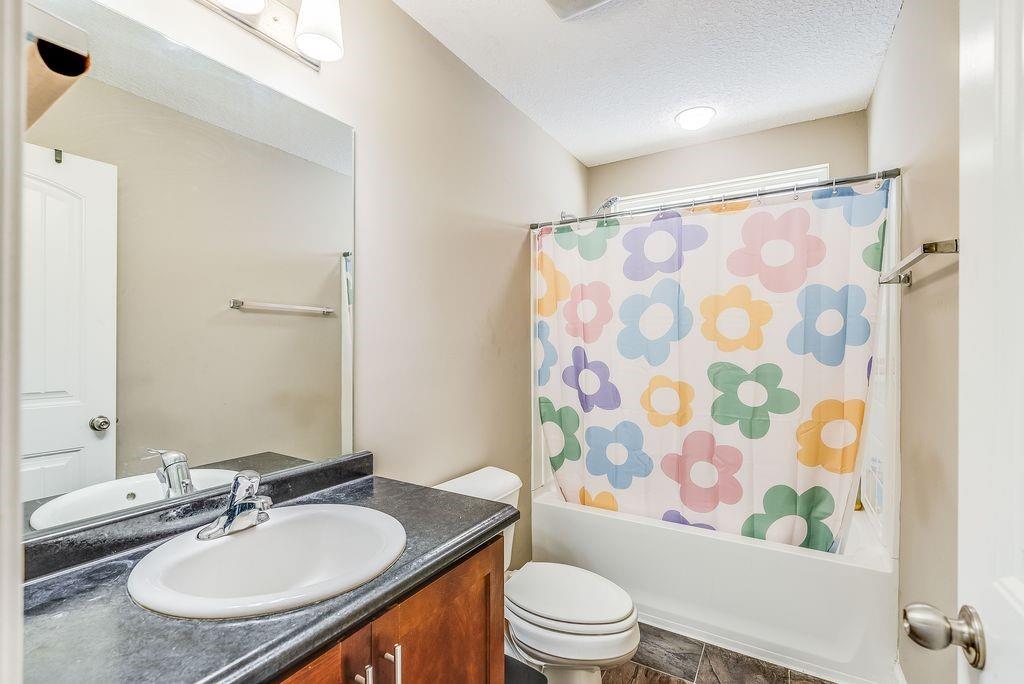 1200 Cypress Fall Circle Hinesville, GA 31313 - Photo 15 of 24 a bathroom with a granite countertop sink toilet a mirror a vanity and shower