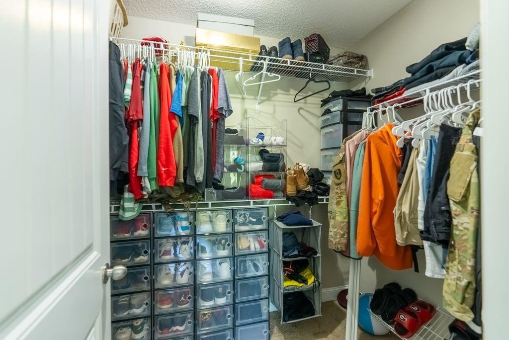 1200 Cypress Fall Circle Hinesville, GA 31313 - Photo 22 of 24 a view of walk in closet with clothes and shoes