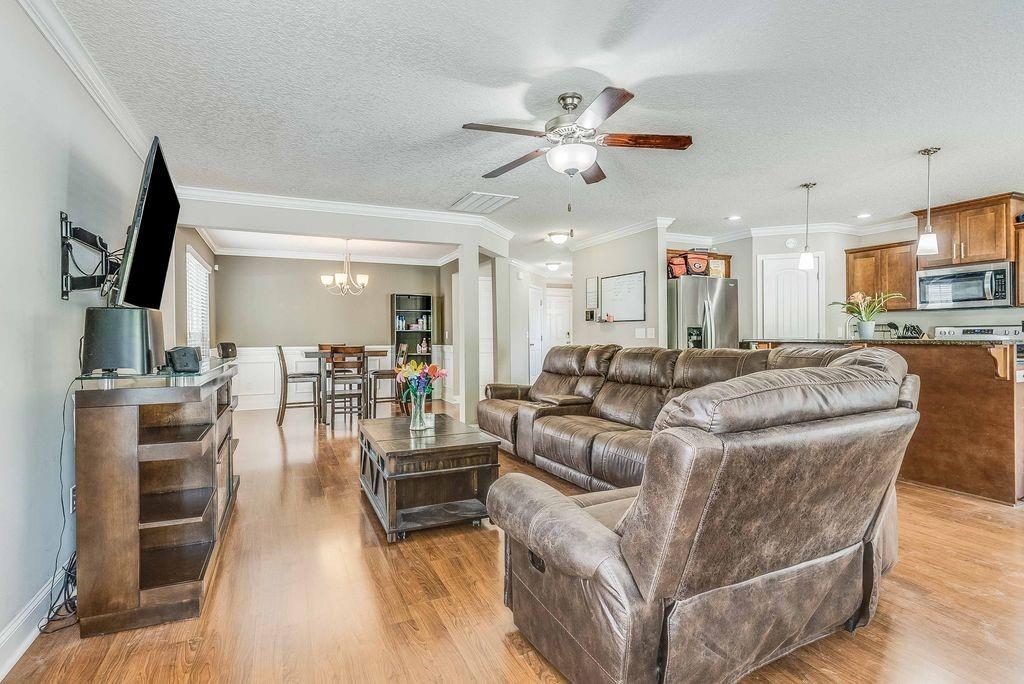 1200 Cypress Fall Circle Hinesville, GA 31313 - Photo 3 of 24 a living room with furniture a dining table and chairs