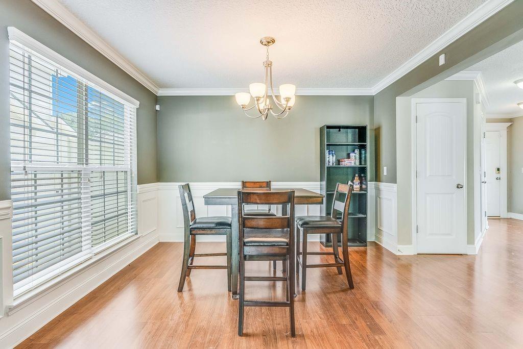 1200 Cypress Fall Circle Hinesville, GA 31313 - Photo 4 of 24 a view of a dining room with furniture window and wooden floor