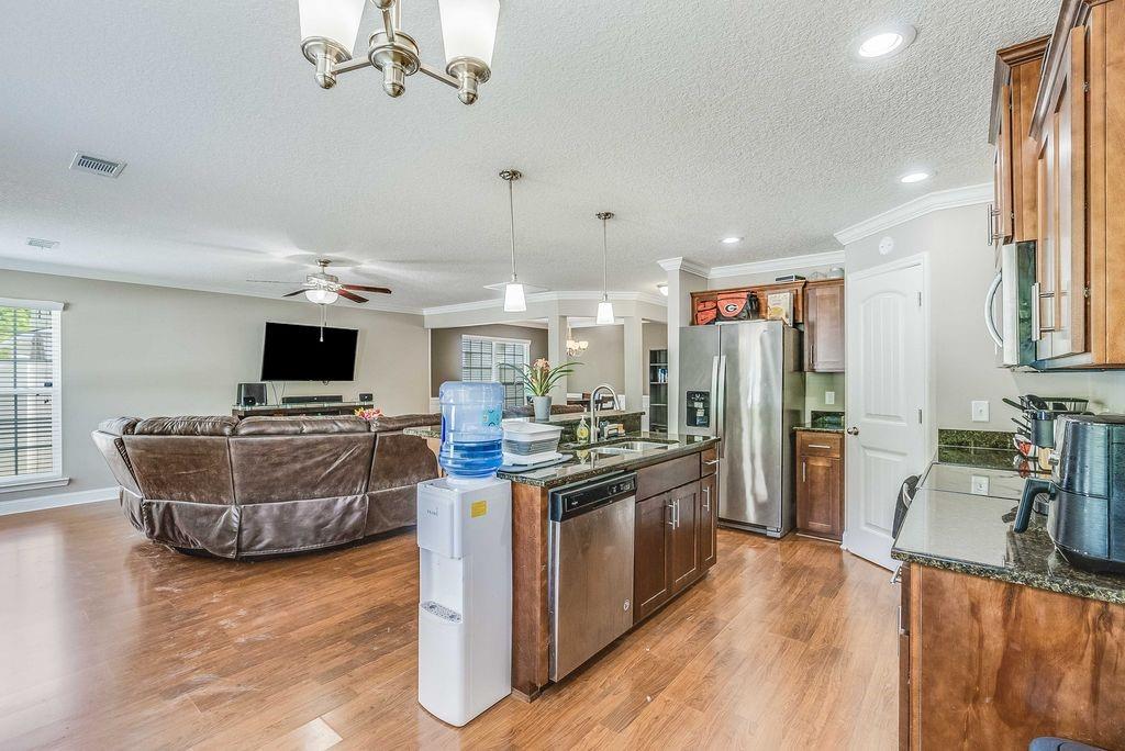 1200 Cypress Fall Circle Hinesville, GA 31313 - Photo 8 of 24 a kitchen with cabinets and stainless steel appliances