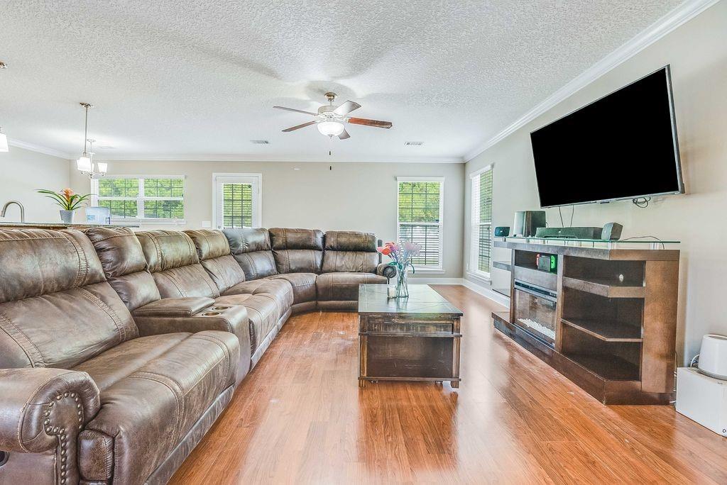 1200 Cypress Fall Circle Hinesville, GA 31313 - Photo 9 of 24 a living room with furniture and a flat screen tv
