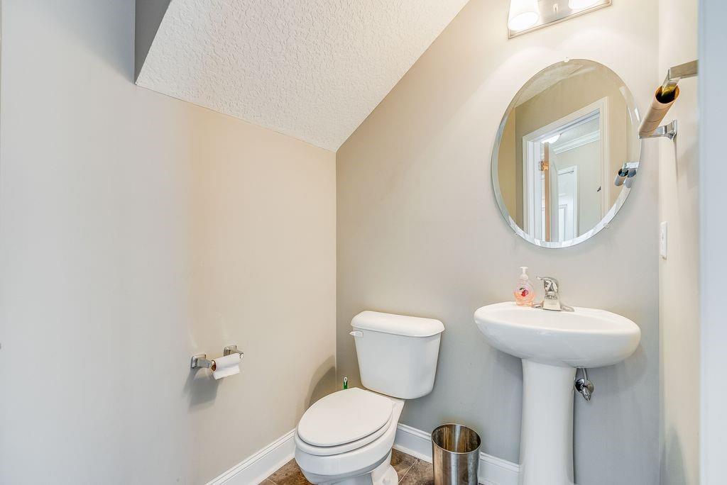1200 Cypress Fall Circle Hinesville, GA 31313 - Photo 10 of 24 a bathroom with a sink mirror and toilet