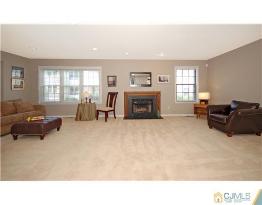 3801 Springbrook Drive Edison, NJ 08820 - Photo 2 of 13 a living room with furniture and a fireplace