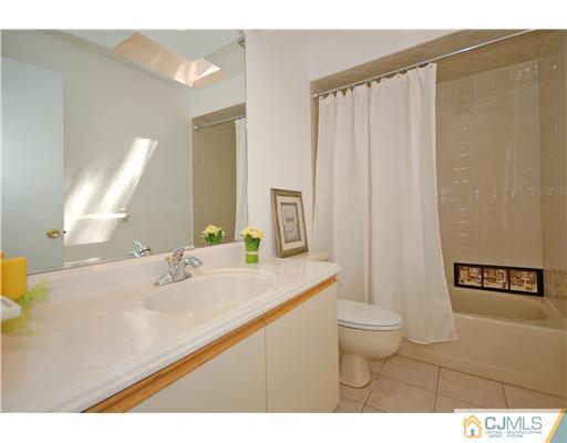 3801 Springbrook Drive Edison, NJ 08820 - Photo 13 of 13 a bathroom with a sink a toilet and mirror