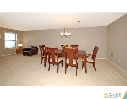 3801 Springbrook Drive Edison, NJ 08820 - Photo 3 of 13 a dining room with furniture and chandelier