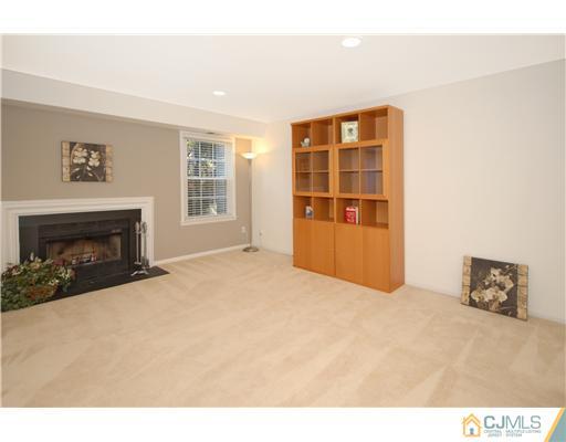 3801 Springbrook Drive Edison, NJ 08820 - Photo 7 of 13 a view of an empty room with a fireplace and a window