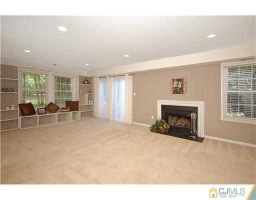 3801 Springbrook Drive Edison, NJ 08820 - Photo 8 of 13 a view of an empty room with window and a fireplace