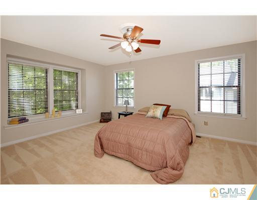 3801 Springbrook Drive Edison, NJ 08820 - Photo 9 of 13 a bedroom with a large bed and a large window