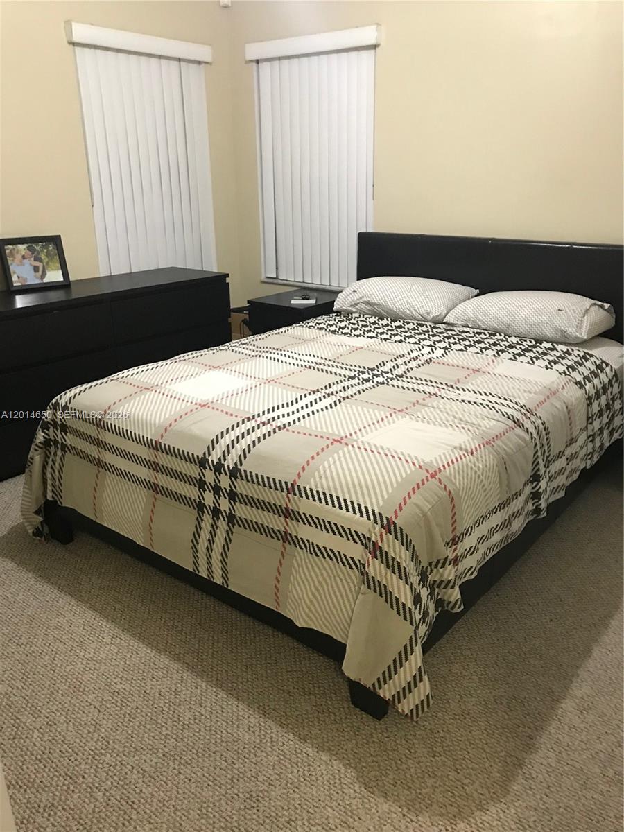 16654 Southwest 103rd Lane Miami, FL 33196 - Photo 10 of 20 a bedroom with a bed and a window