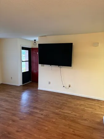 a view of a livingroom with wooden floor