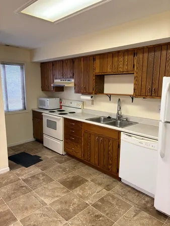 a kitchen with stainless steel appliances granite countertop a stove a sink dishwasher and a refrigerator