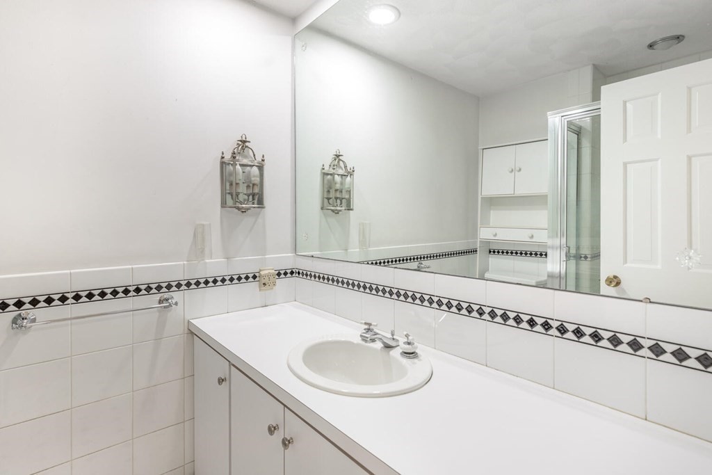 116 Kendall Road Lexington, MA 02421 - Photo 17 of 28 a bathroom with a granite countertop sink and a mirror