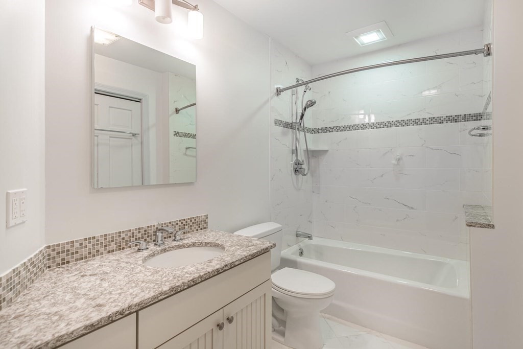 116 Kendall Road Lexington, MA 02421 - Photo 24 of 28 a bathroom with a granite countertop sink a toilet and shower
