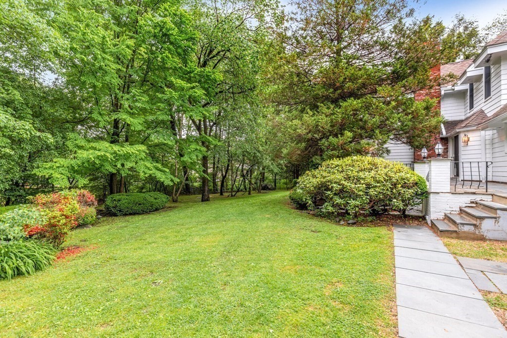 116 Kendall Road Lexington, MA 02421 - Photo 27 of 28 a view of a backyard with plants and large trees