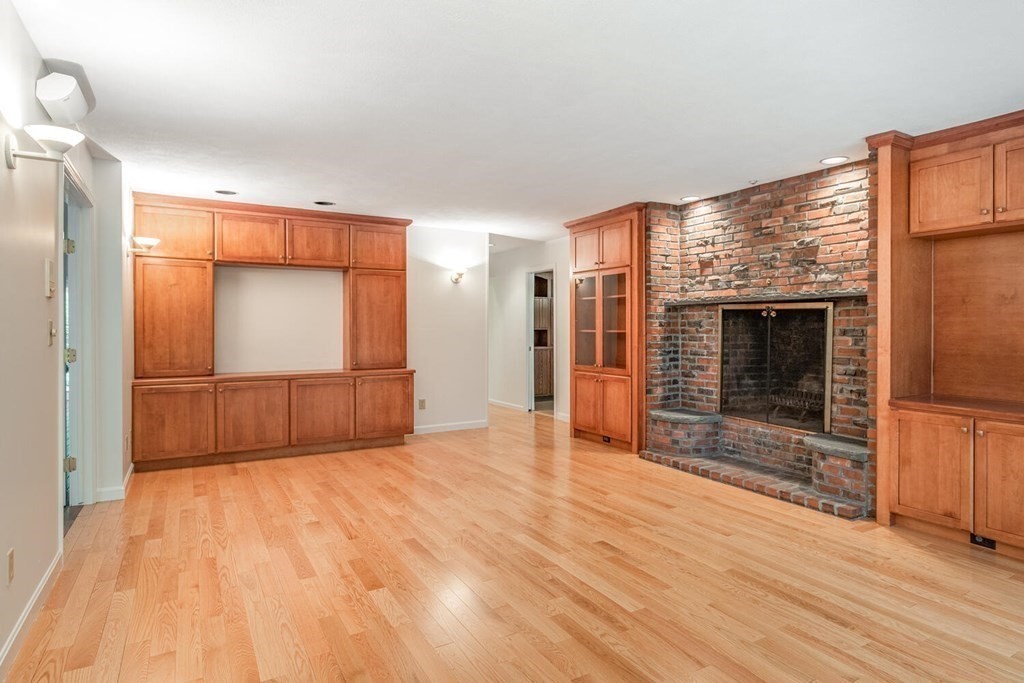 116 Kendall Road Lexington, MA 02421 - Photo 8 of 28 a view of empty room with wooden floor and fireplace
