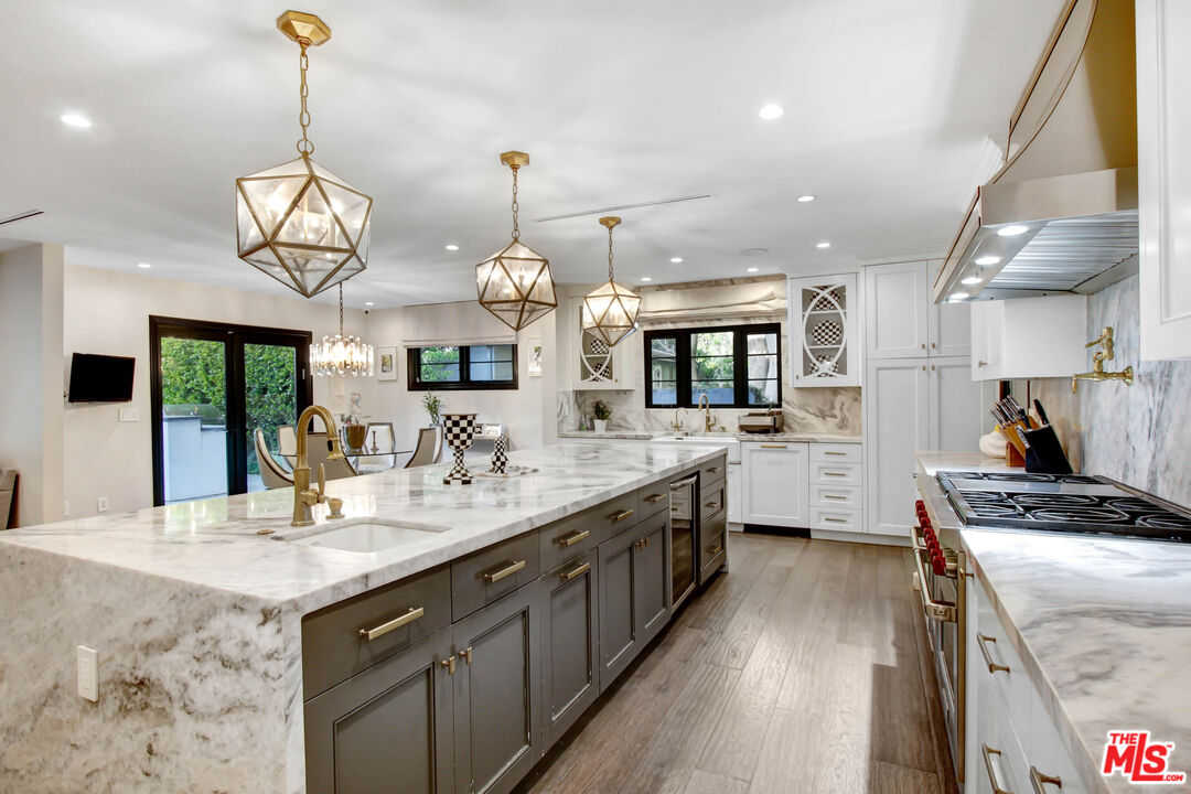 a kitchen with granite countertop cabinets a sink and appliances