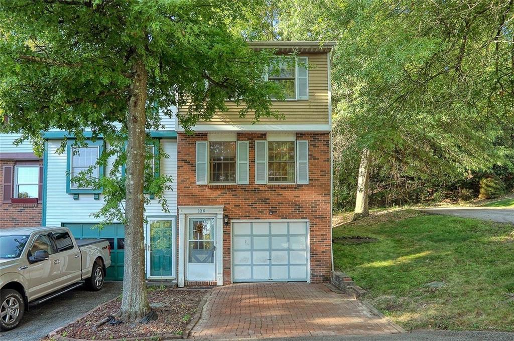 a view of a house with a backyard