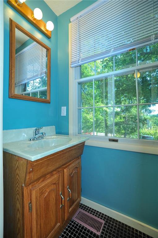 320 Sugar Maple Circle Washington, PA 15301 - Photo 12 of 23 a bathroom with a sink a large mirror and a window