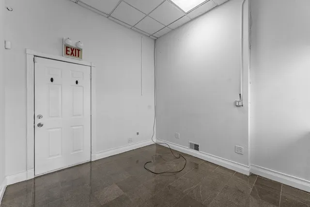 a utility room with a toilet and a sink