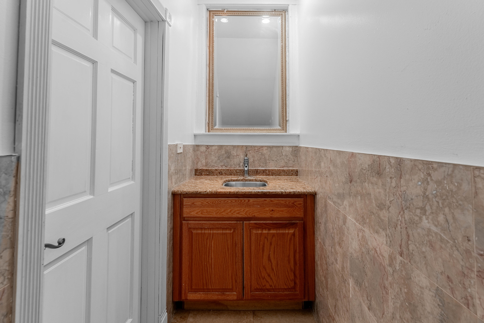 4325 West 26th Street Chicago, IL 60623 - Photo 7 of 13 a bathroom with a sink and a mirror