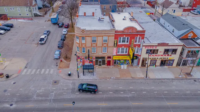 an aerial view of a hall with wooden stairs