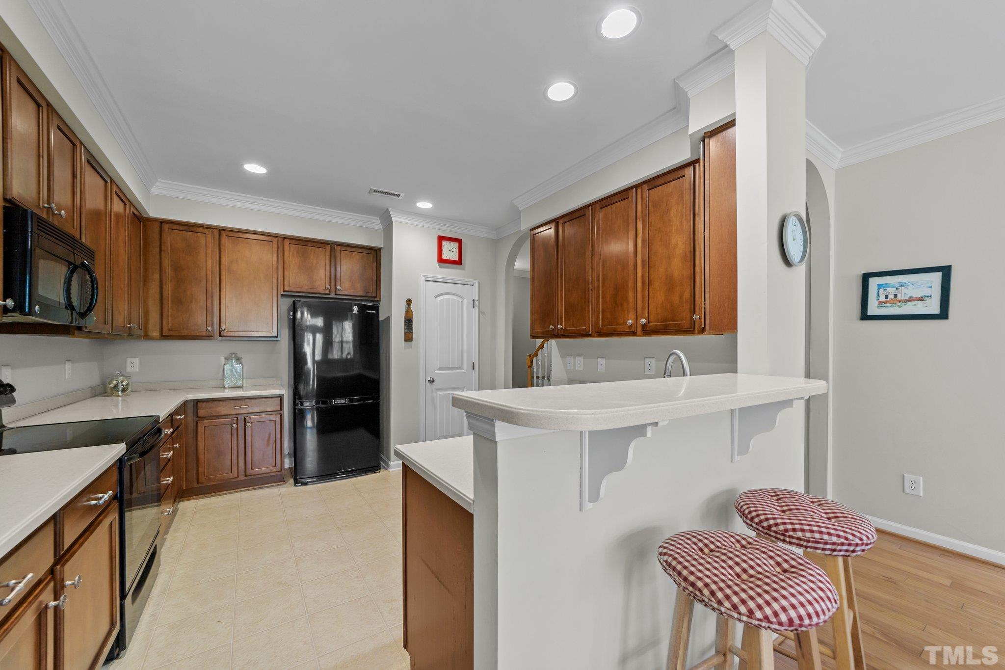 4728 Altha Street Raleigh, NC 27606 - Photo 14 of 31 a kitchen with refrigerator cabinets and furniture