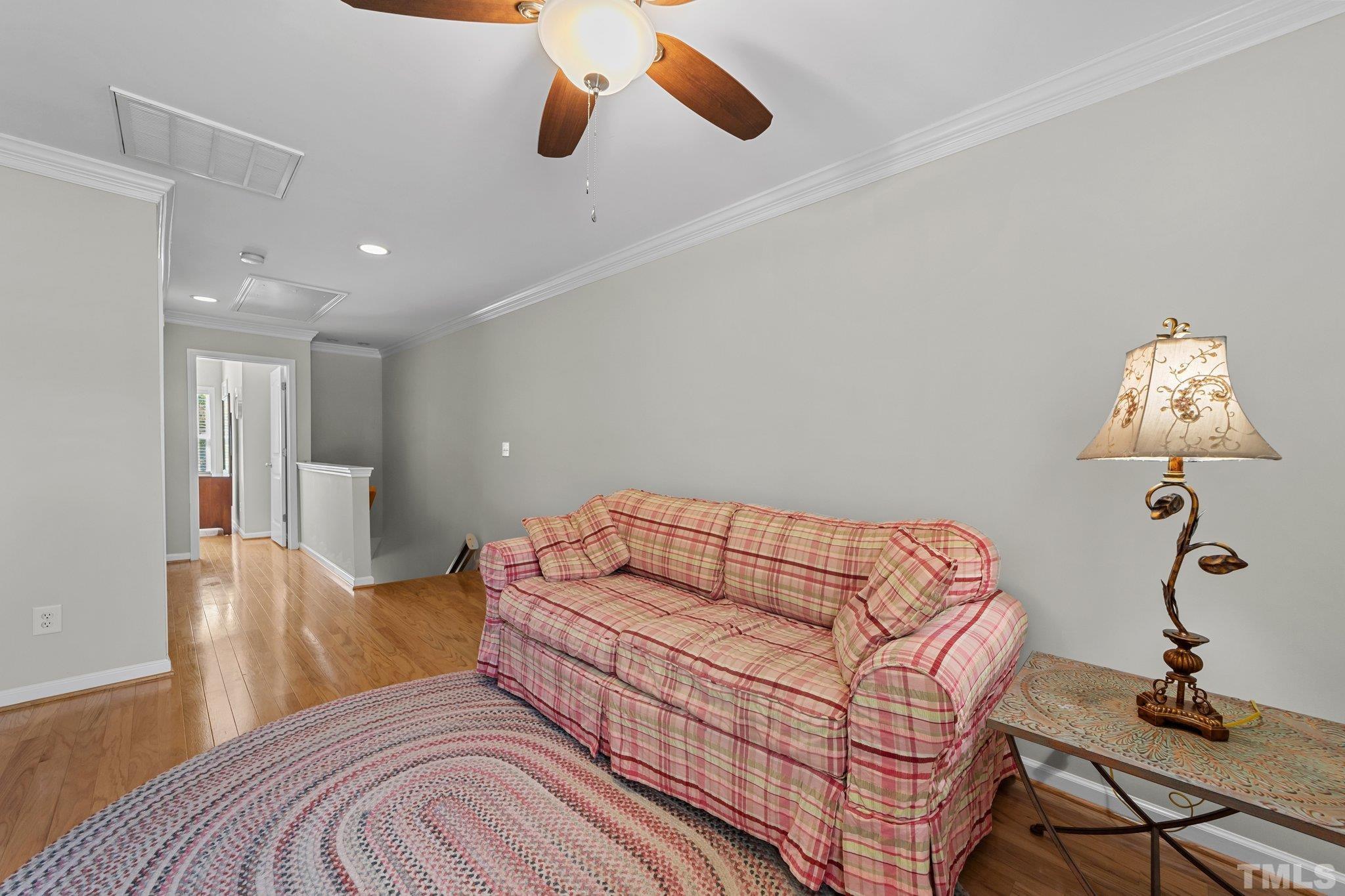 4728 Altha Street Raleigh, NC 27606 - Photo 18 of 31 a bedroom with a bed and wooden floor
