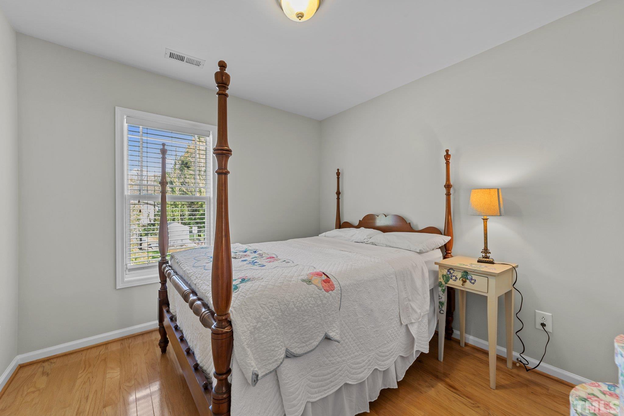 4728 Altha Street Raleigh, NC 27606 - Photo 19 of 31 a bedroom with a bed and wooden floor