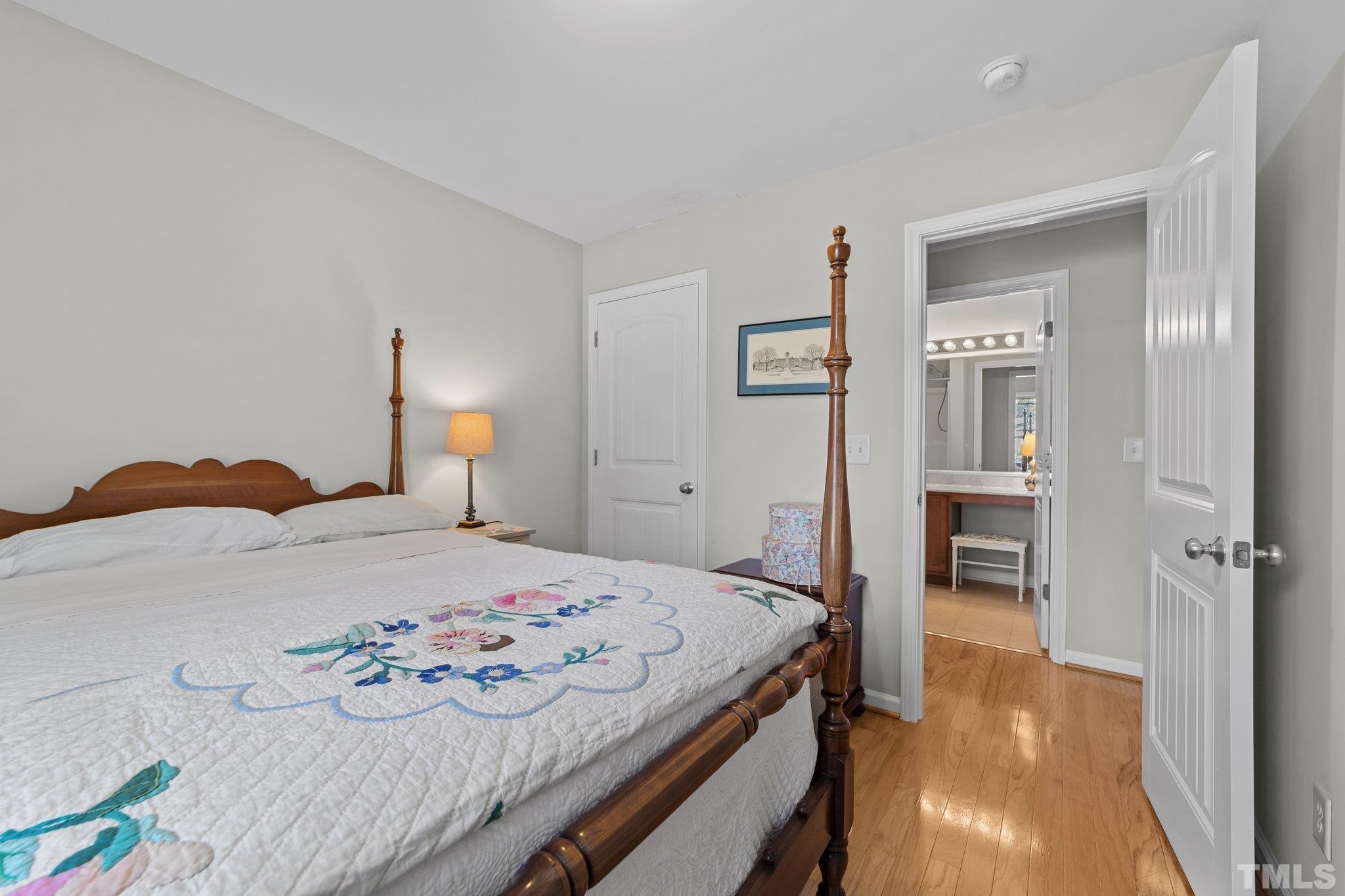 4728 Altha Street Raleigh, NC 27606 - Photo 20 of 31 a bedroom with a bed and a view of bathroom