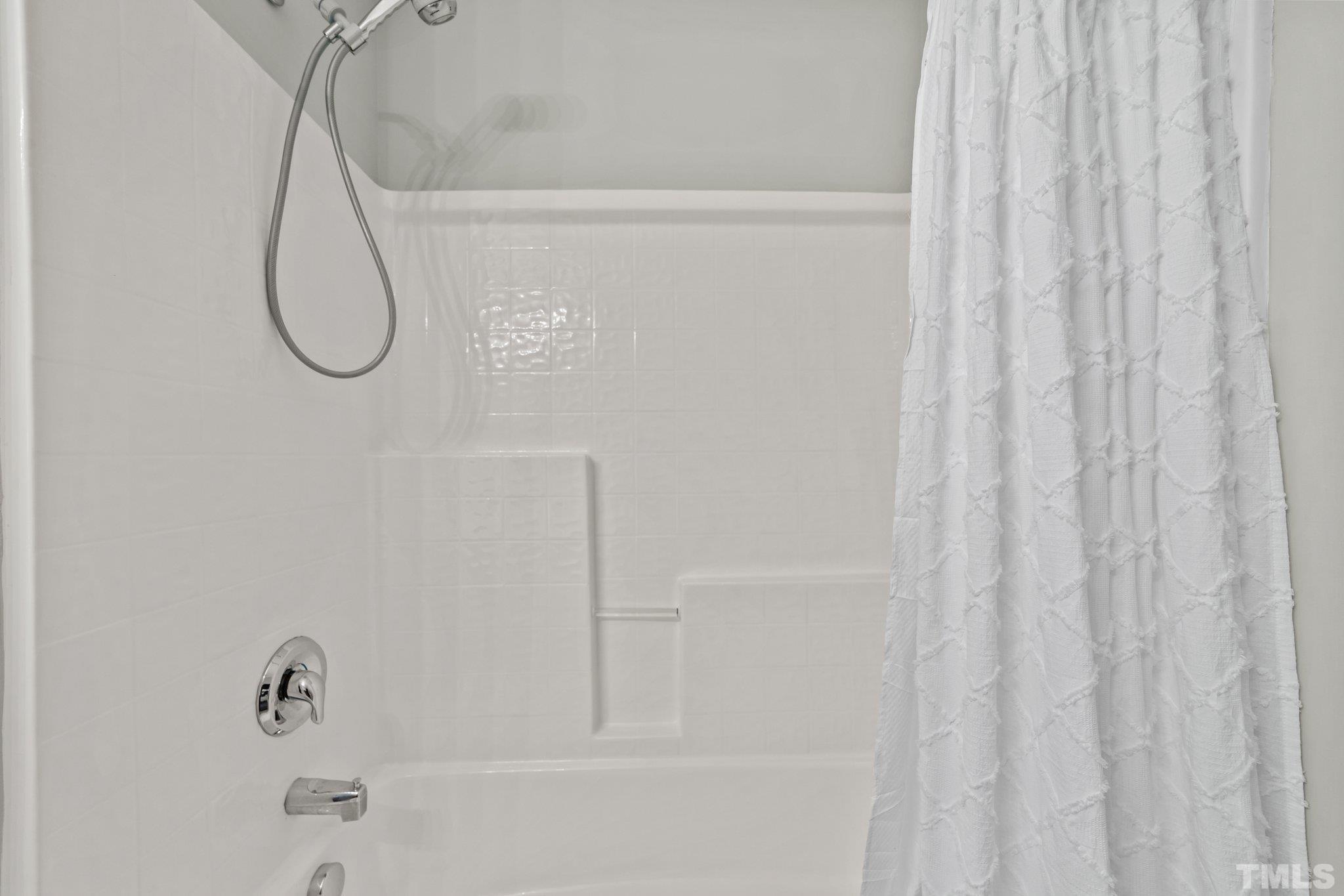 4728 Altha Street Raleigh, NC 27606 - Photo 22 of 31 a bathroom with a glass shower door