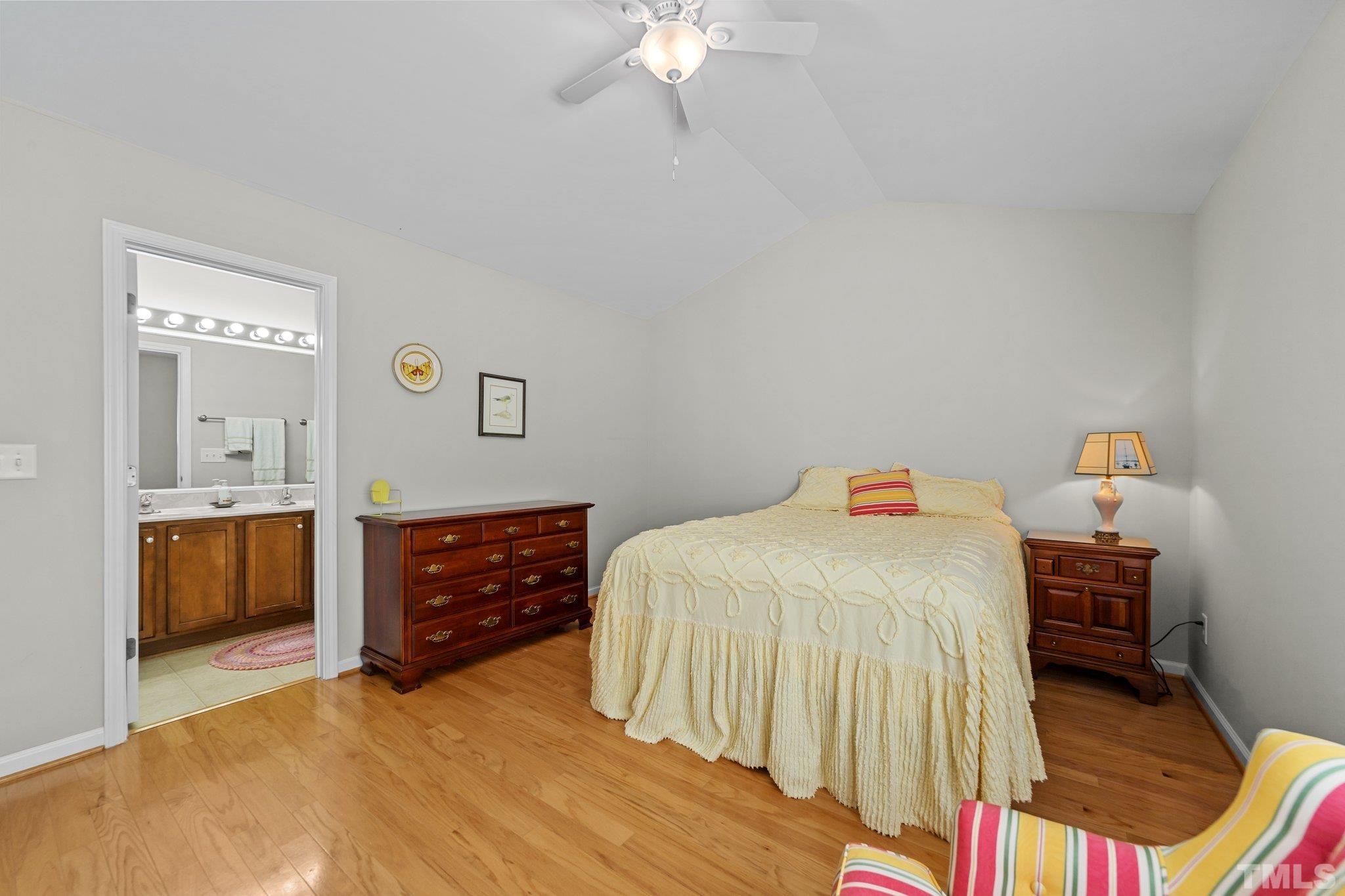 4728 Altha Street Raleigh, NC 27606 - Photo 24 of 31 a bedroom with a bed and a chandelier