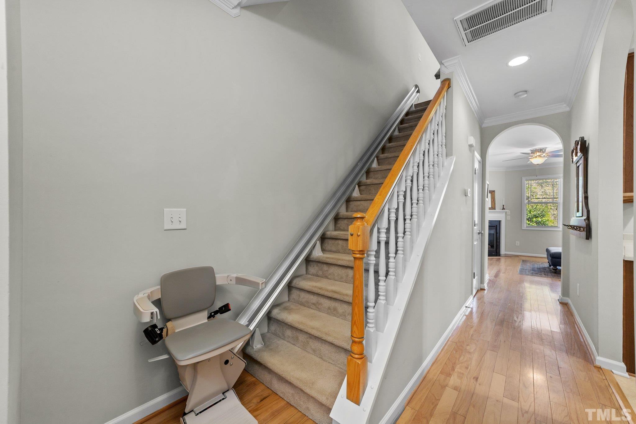 4728 Altha Street Raleigh, NC 27606 - Photo 5 of 31 a view of a hallway with wooden floor and stairs